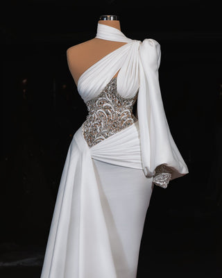 Elegant one-shoulder bridal gown with crystal-embellished bodice and flowing silk train.