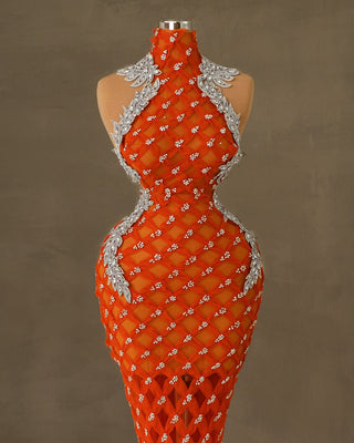 Long luxury orange dress with silver stone embellishments and a high neck design