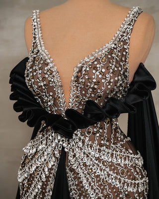 Close-up of black dress detailing silver stone embellishments and thin straps