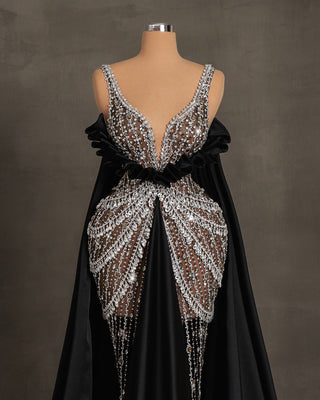 Elegant long black dress with silver stones, open chest design, and satin capes and tail