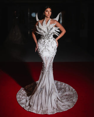 A stunning 3D bridal dress with a mermaid silhouette, adorned with beads, crystals, and a dramatic sculptural bodice.