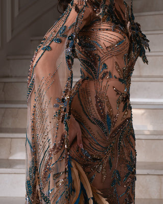 Asymmetrical dress with feather detail for evening wear.