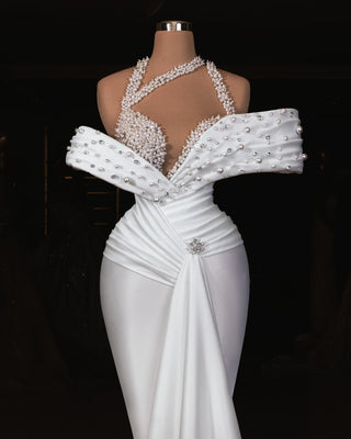 Elegant off-shoulder bridal dress with pearl embellishments.