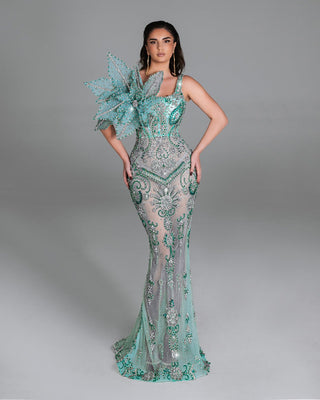 Seafoam green dress with crystal embellishments and a floral shoulder design.