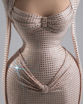 Champagne-toned evening gown with intricate crystal embellishments and a futuristic hourglass silhouette.