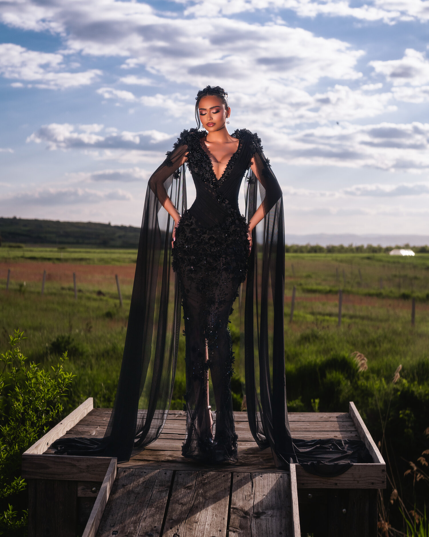 NOIRA — front portrait, cape sleeves drifting at sunset